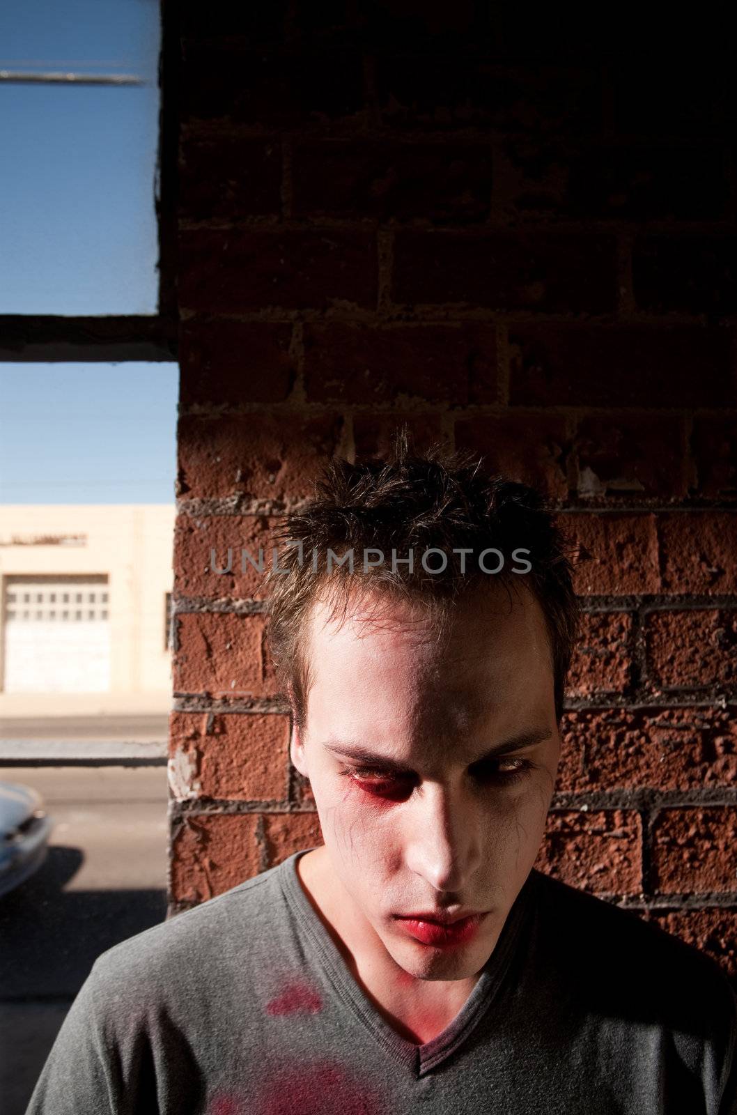 Young Male Zombie Standing in front of Brick Wall