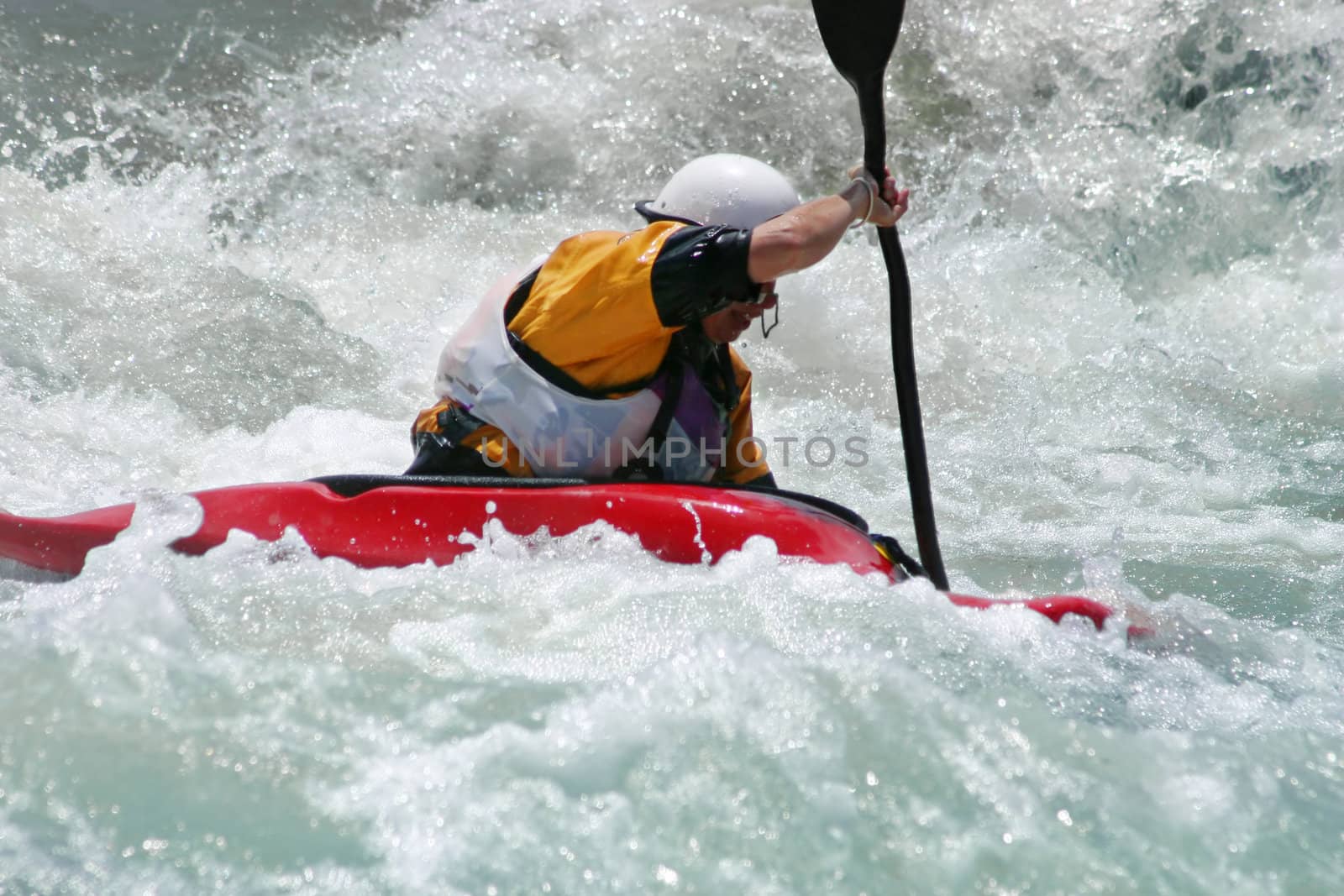Extreme action - A kayaker battling strong rapids