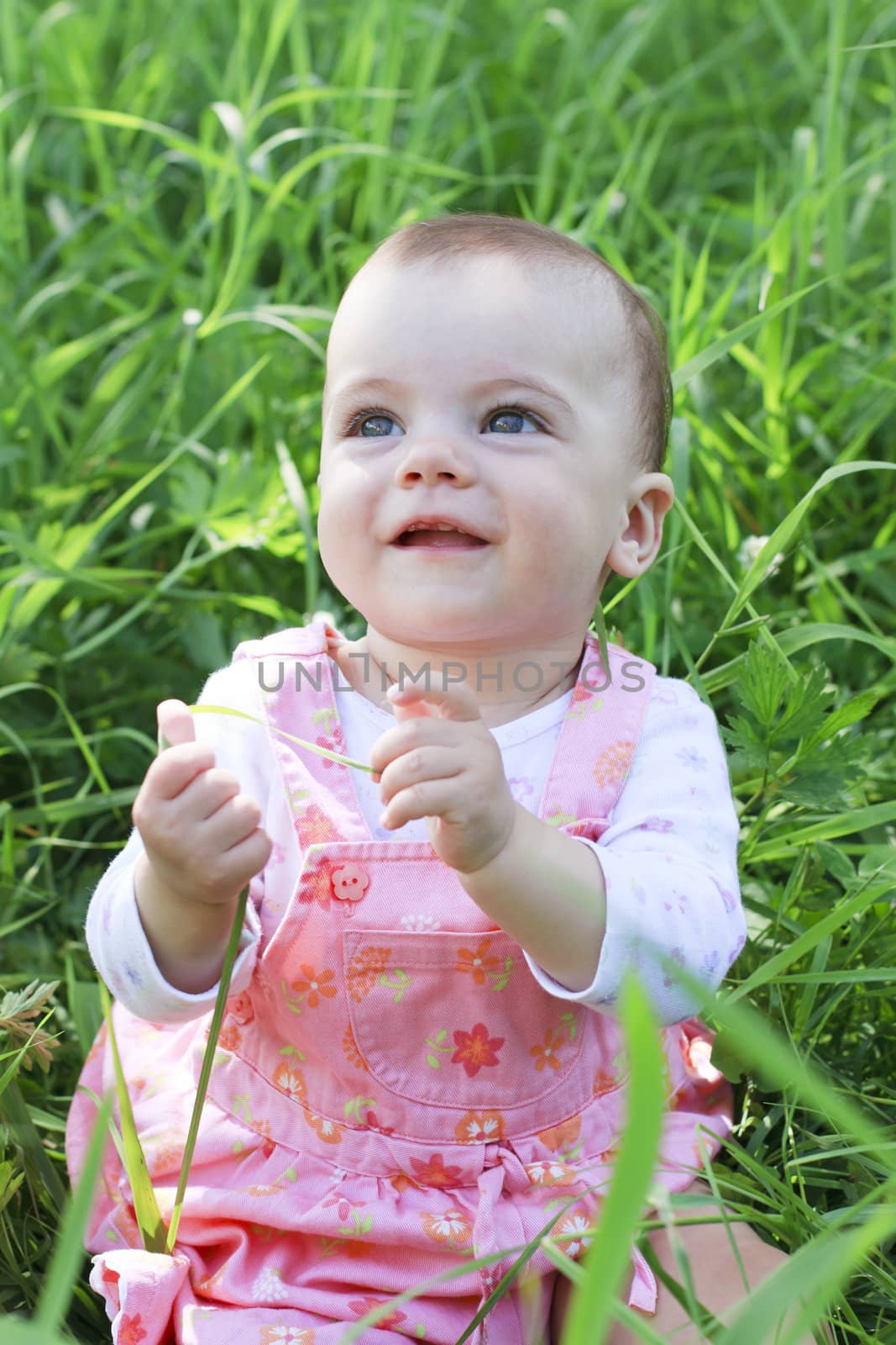 Happy baby girl on grass