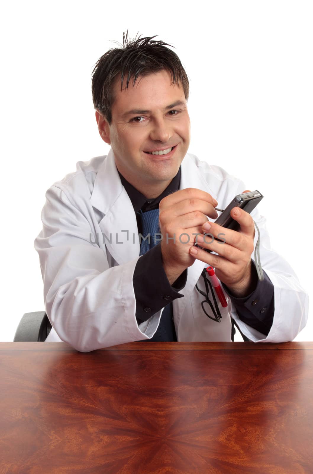 A doctor sitting at desk is using a pda