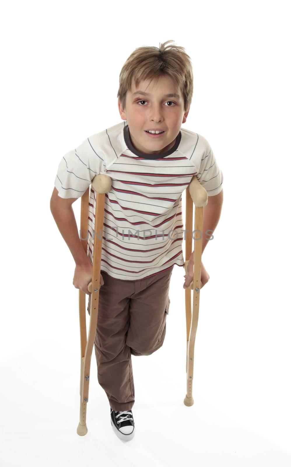 An injured child with sprained ankle using crutches.