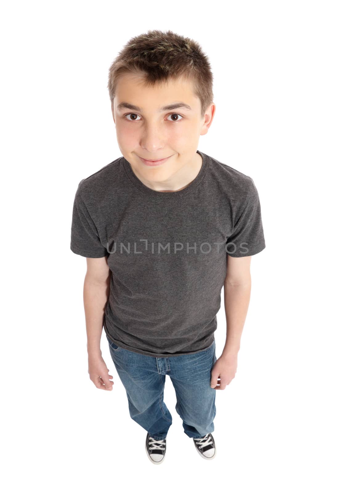 A friendly smiling boy standing in casual blue jeans and blank grey marle t-shirt.  Focus to face only with dof falloff.