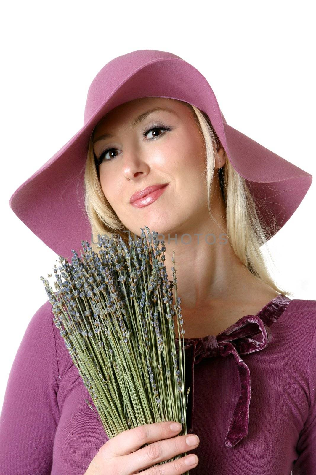 Woman with a bunch of dried lavender.  Originally found in the Mediterranean countries, the  herb lavender, has long been used for it�s perfume and medicinal qualities. The ancient Romans used it for healing and antiseptic qualities.  The name itself comes from the Latin "lavare" to wash. 

