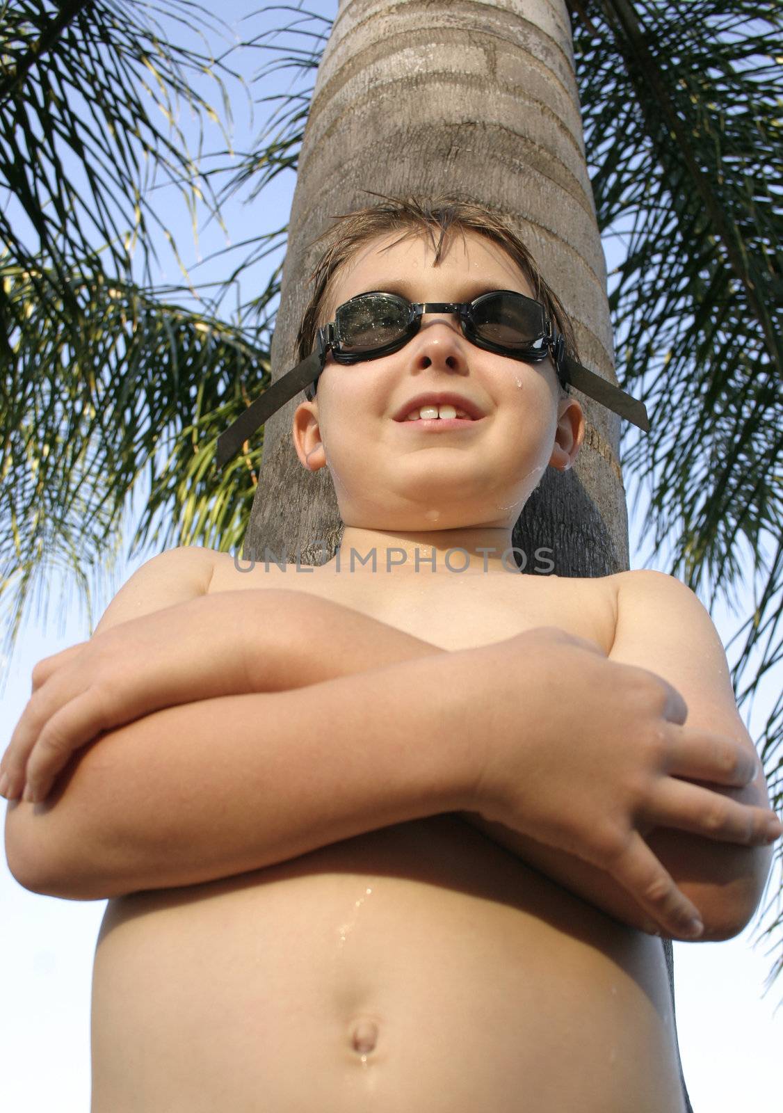 A swimmerstanding under a palm tree.
Angled perspective.