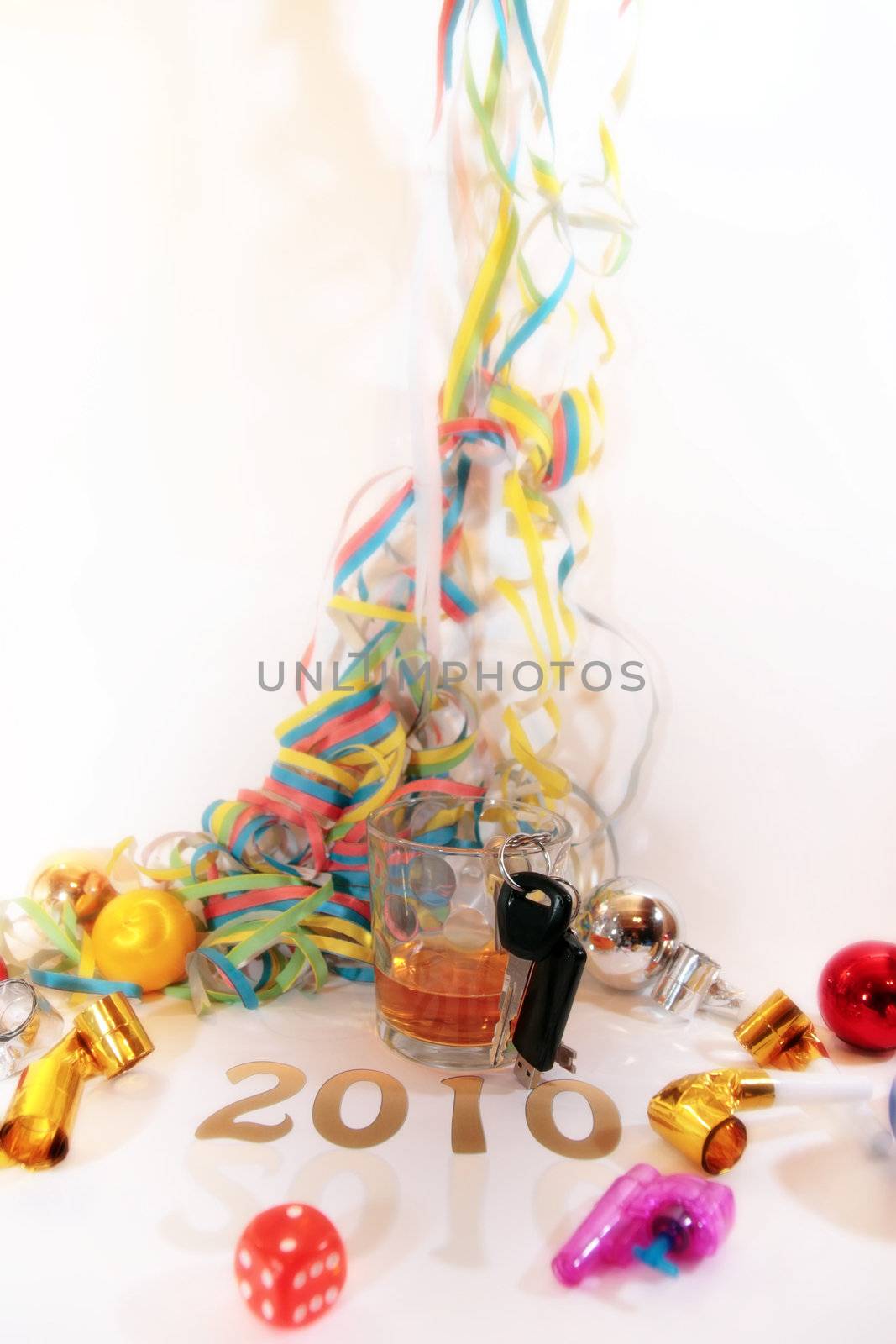 whiskey glass with keys in glass on white background depicting drunk driving and addictions can kill