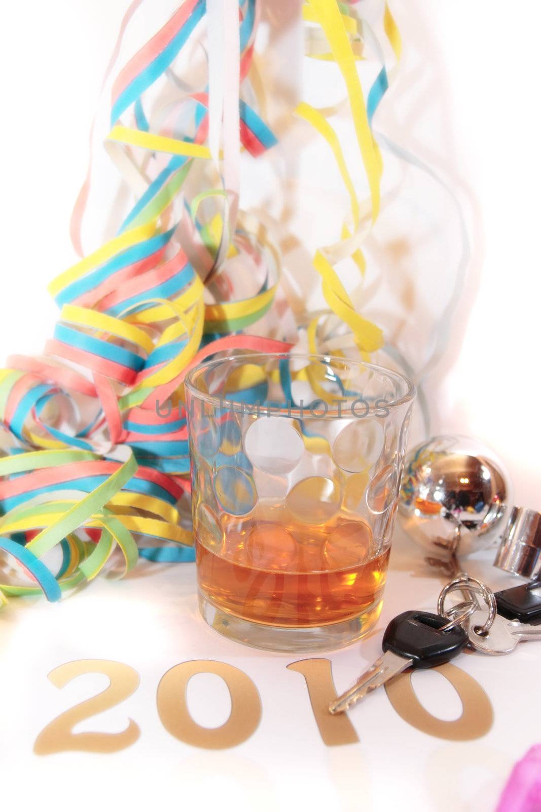 whiskey glass with keys in glass on white background depicting drunk driving and addictions can kill