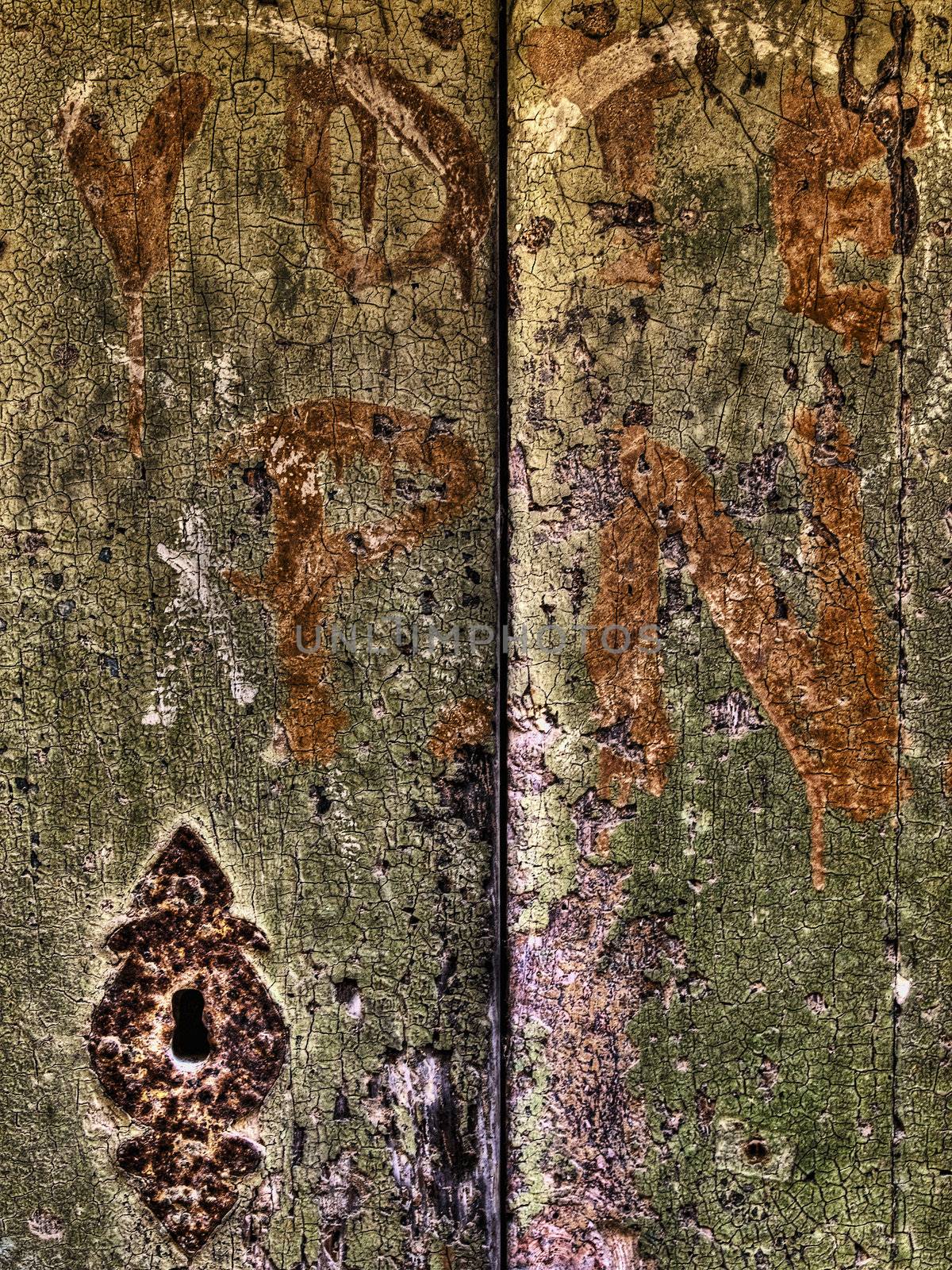 HDR image of scribblings and graffiti on an old door in Mdina