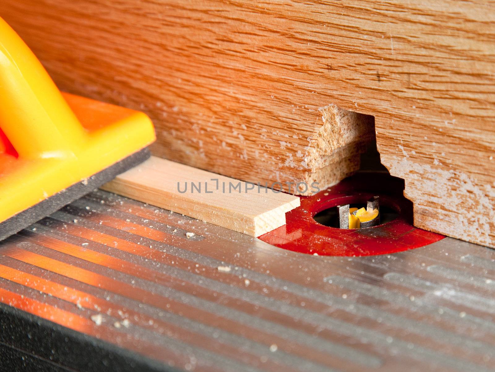Macro shot of router bit cutting into a piece of wood