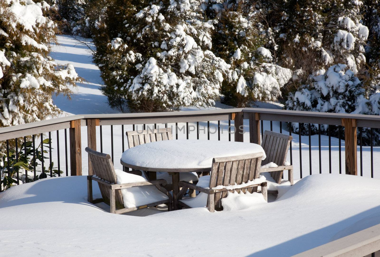 Snowy modern deck with wooden table by steheap