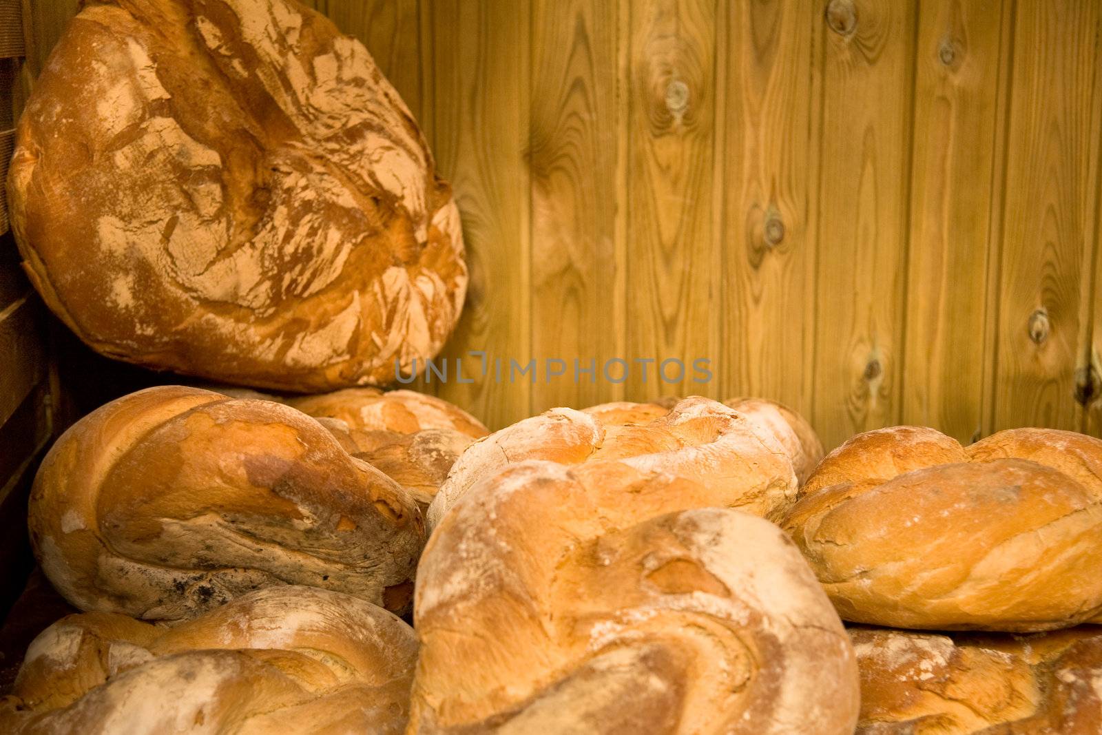 Fresh bread on a wooden market stall. Shallow focus.