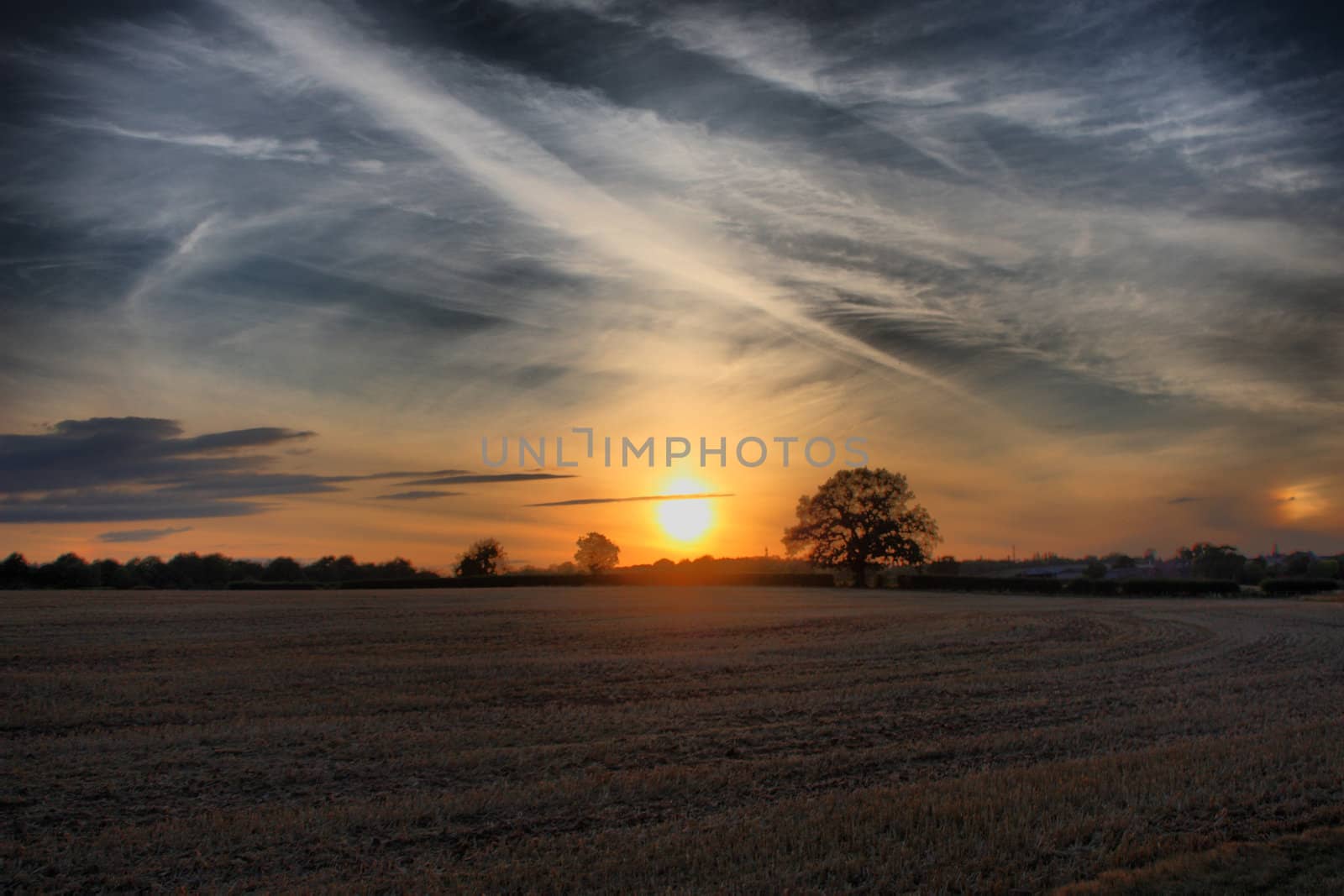 Sun setting over a rural scene