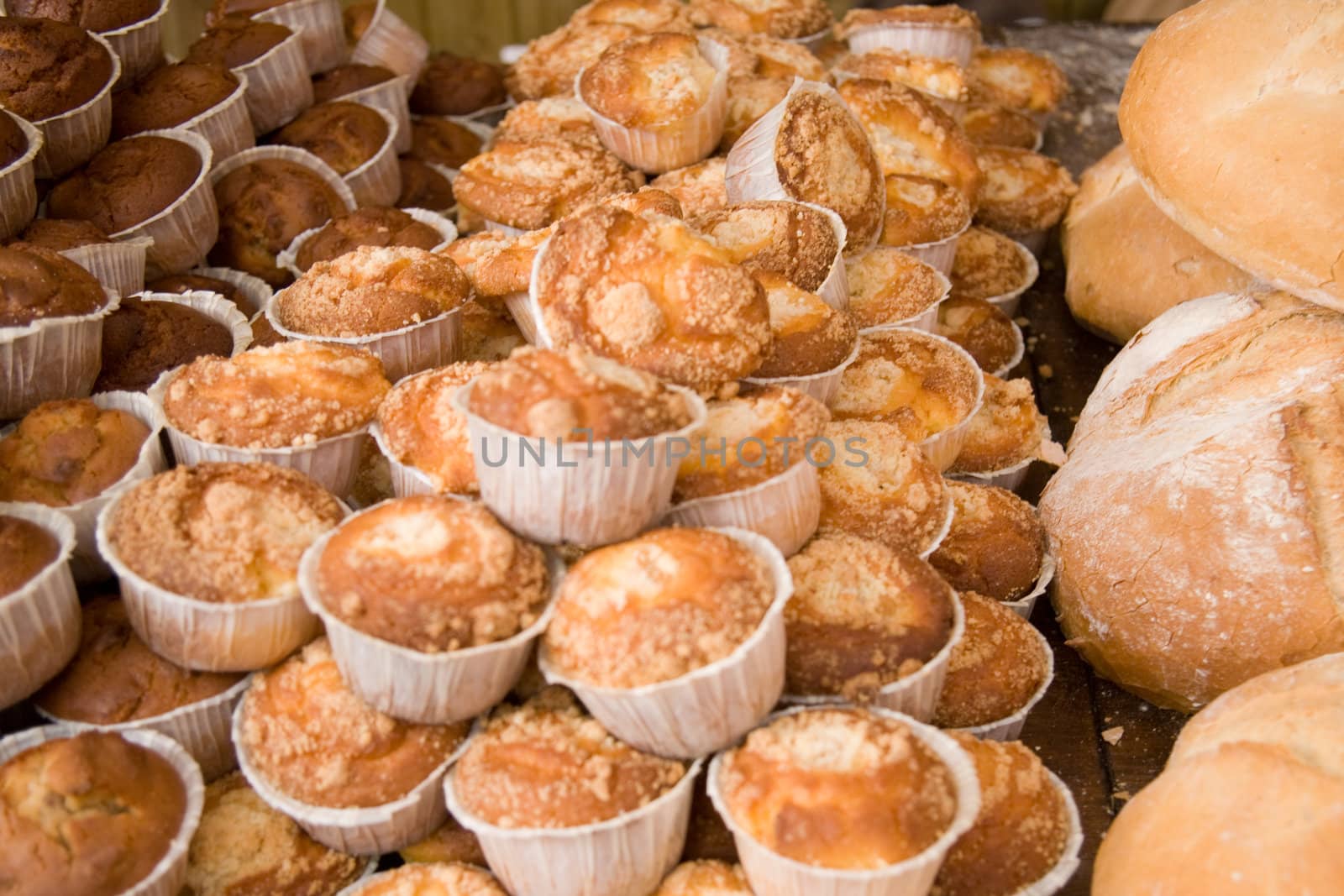 Bread and muffins on a wooden table. Shallow focus.