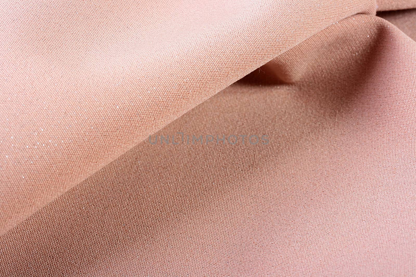 Background from a beige fabric which is used in a clothing industry.