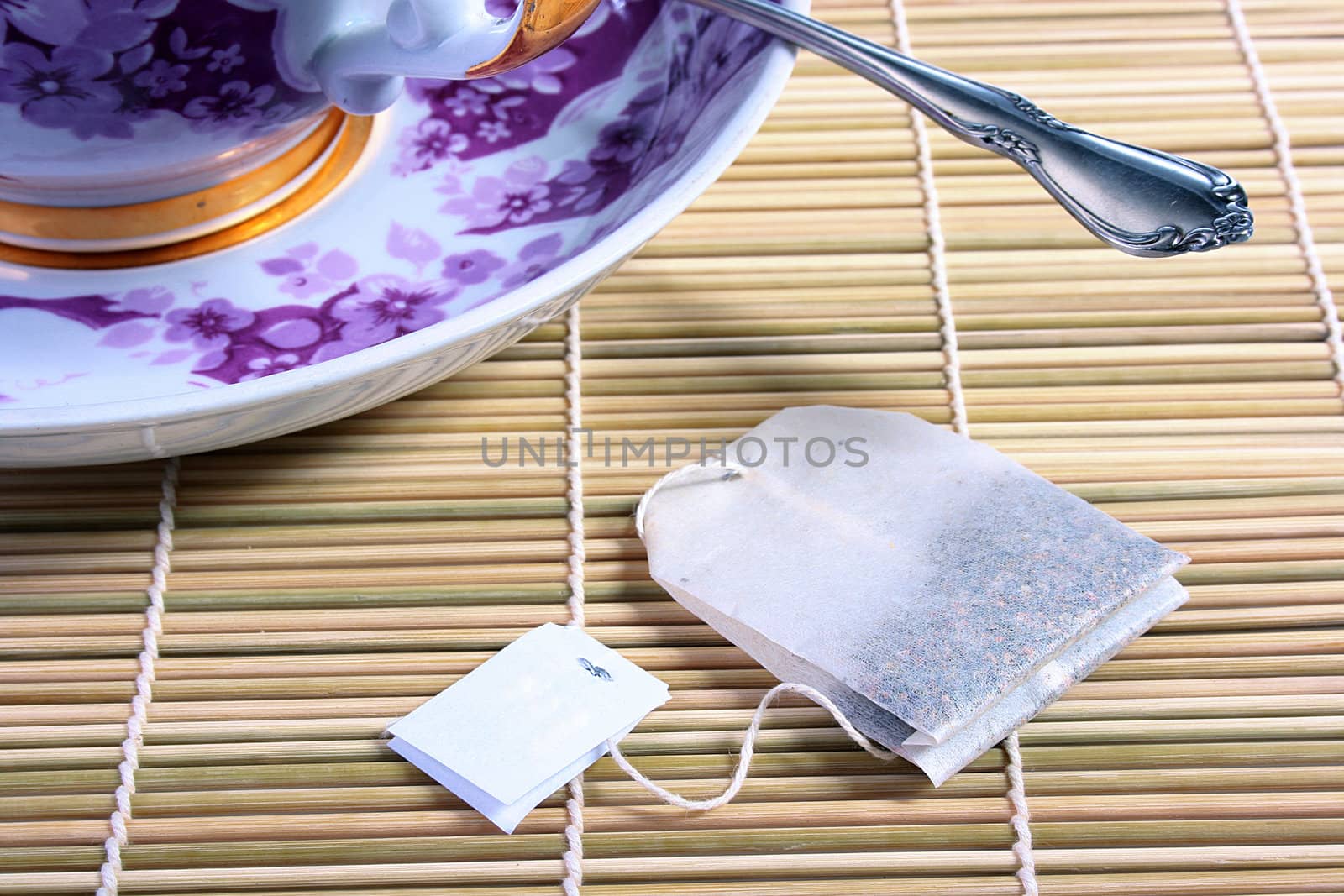 Paper bag with tea and the big cup for tea on a background.