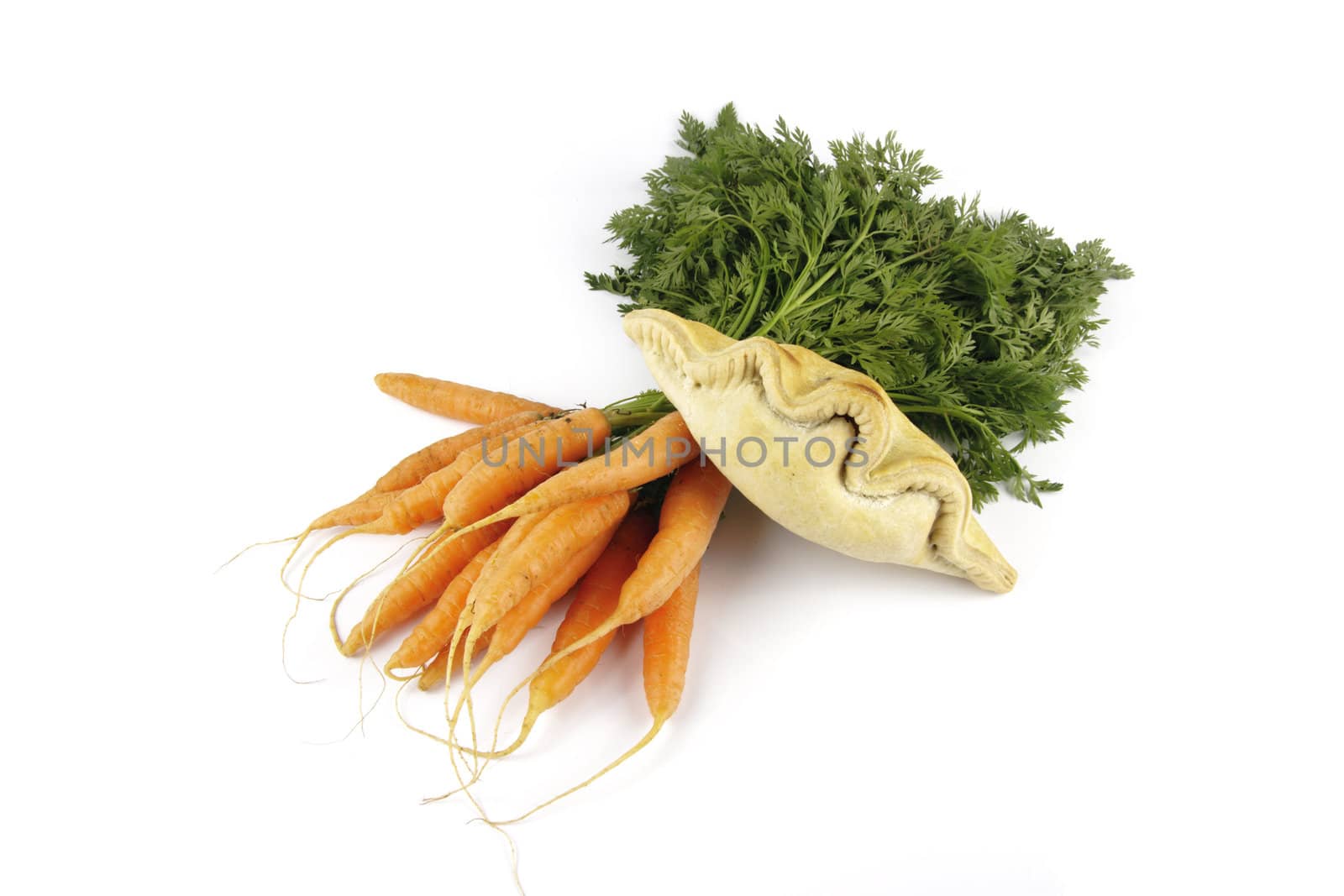 Contradiction between healthy food and junk food using bunch of carrots and pasty on a reflective white background 