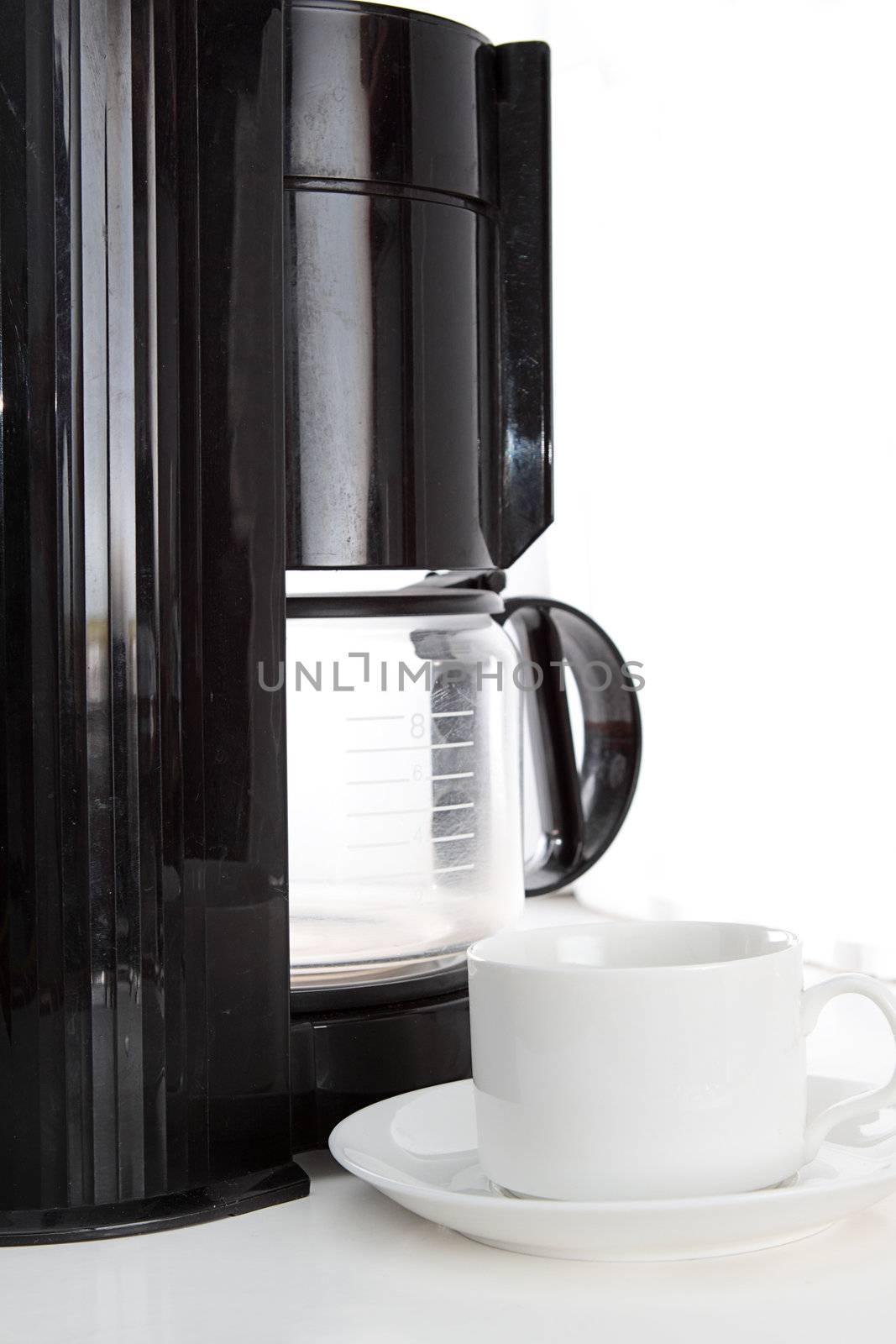 Coffee machine and cup on white