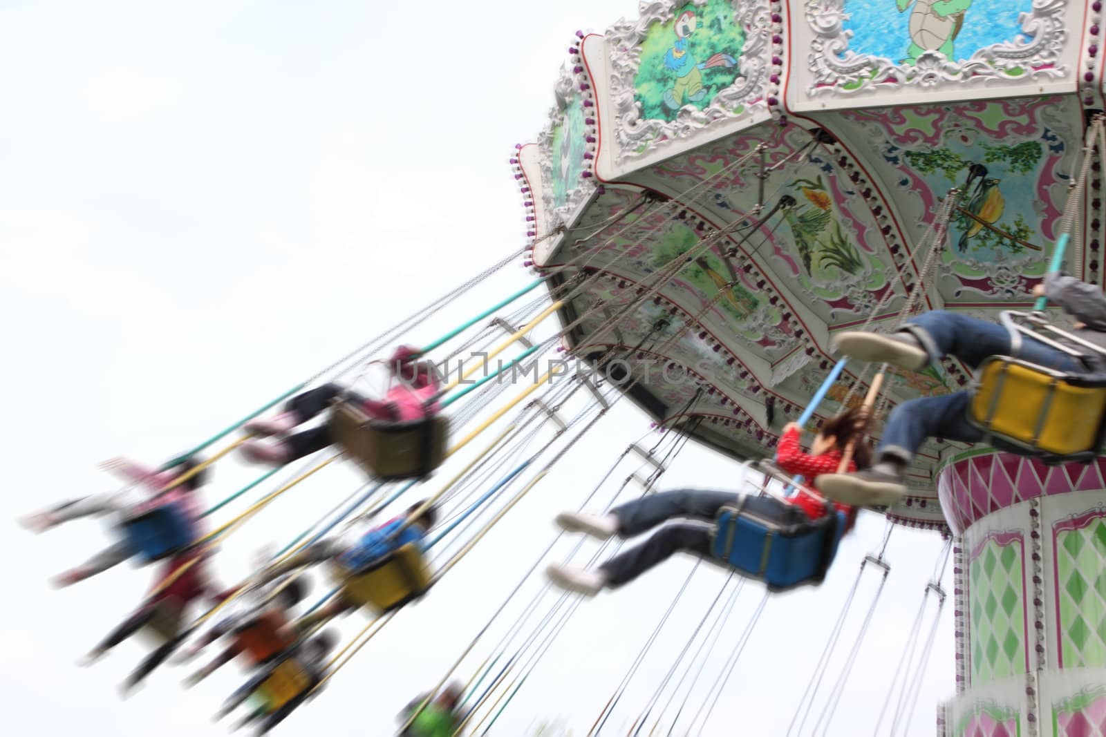 child plaaying flying swing in park