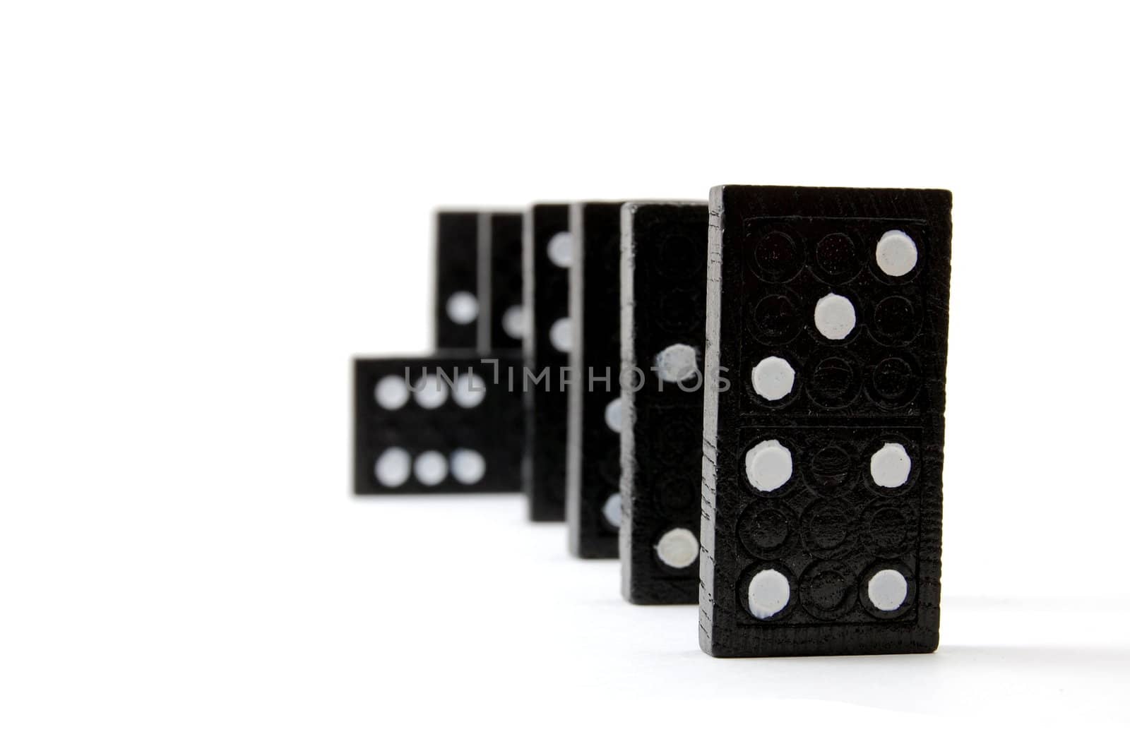 row of dominoes including a special domino stone isolated on white background