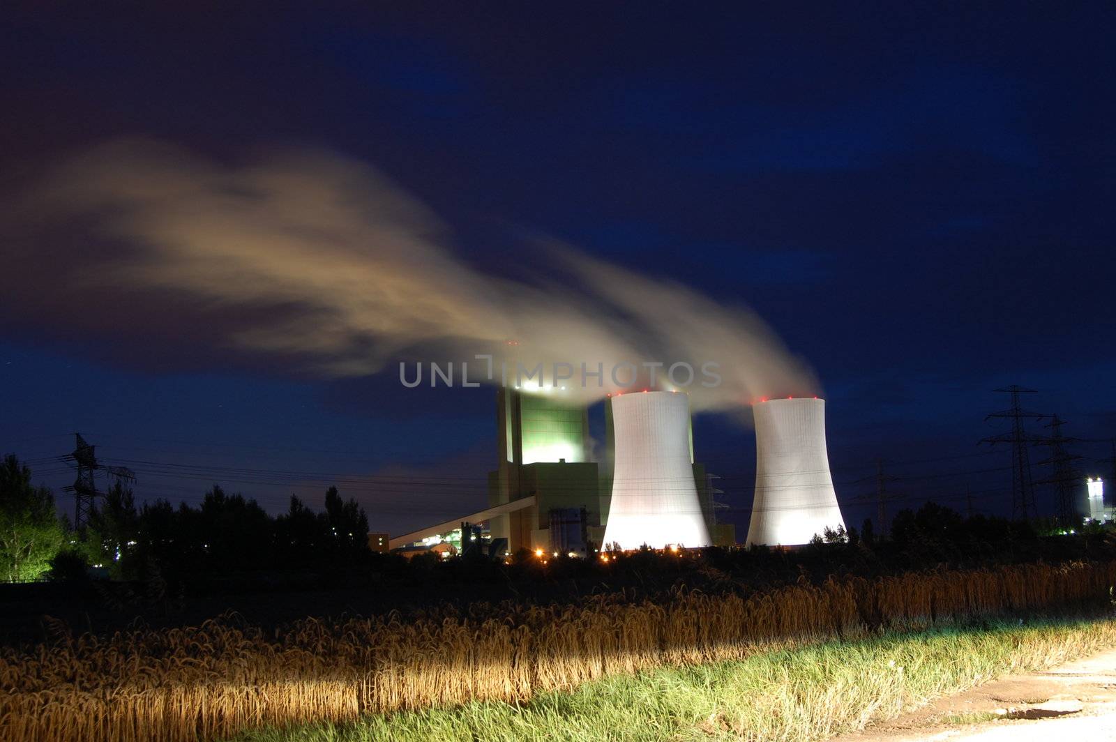 a smoking industrial power plant at night