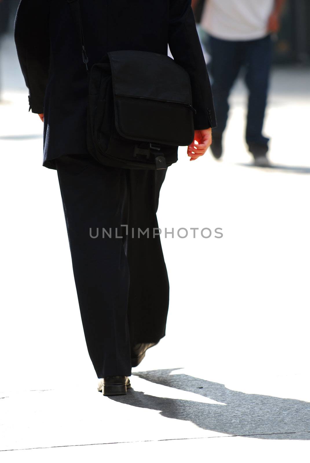 Businessman walking on a busy street downtown