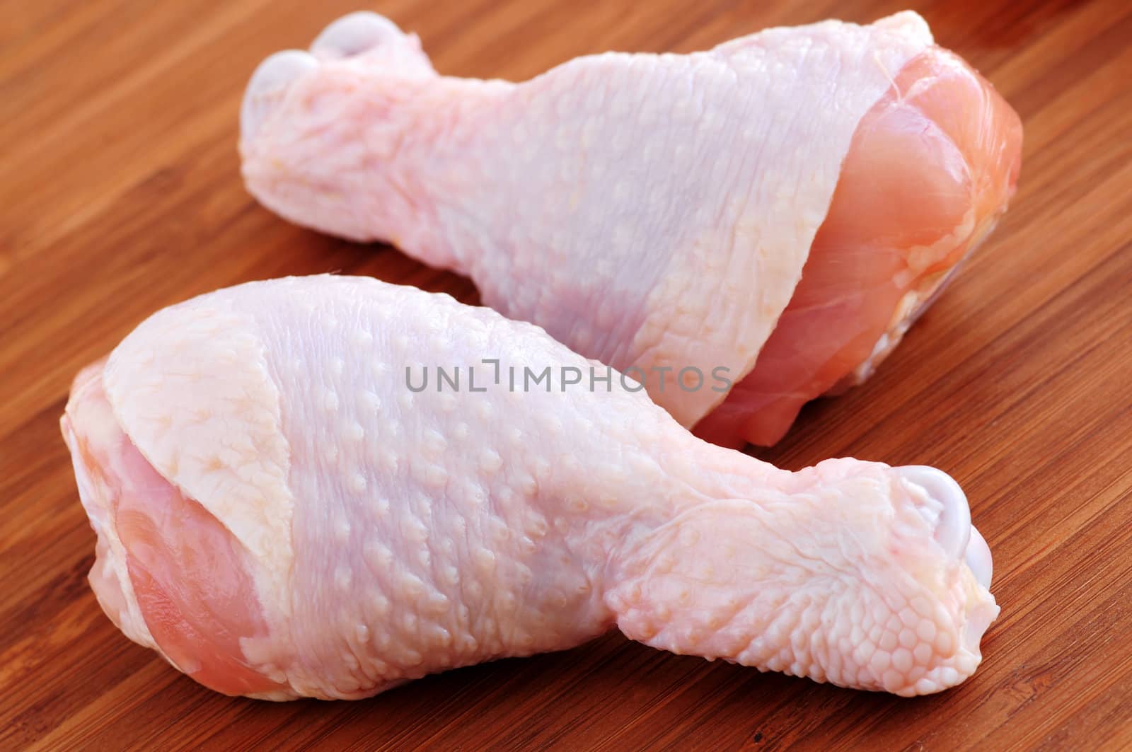 Raw chicken drumsticks by elenathewise