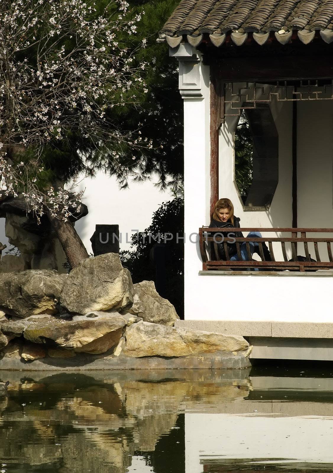 Lonely woman in an authentic Asian garden      