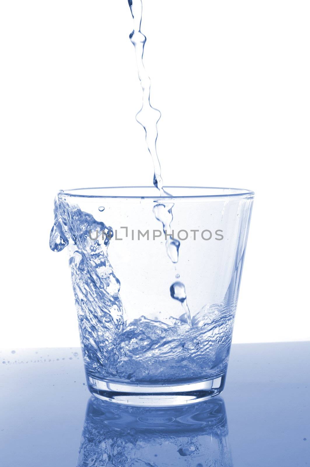 filling a glass with water showing a food concept