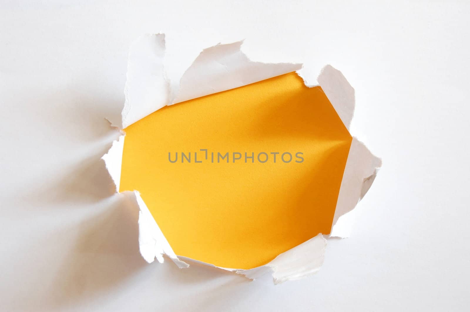 yellow hole in blank sheet paper with copyspace