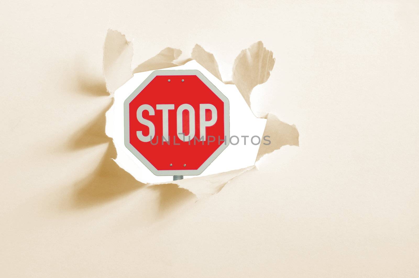 isolated stop sign in a paper hole