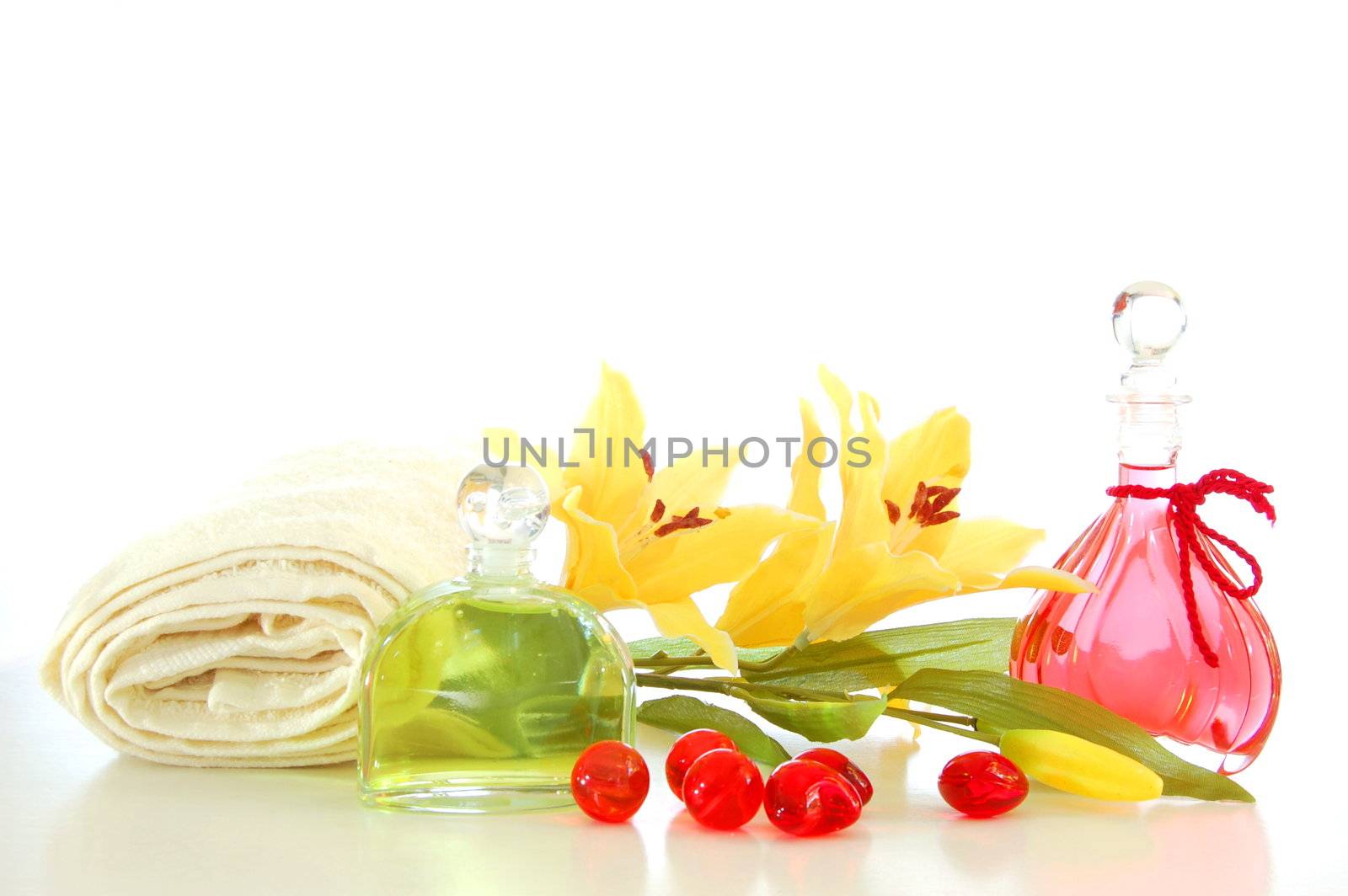 massage still life with bottle of oil and towel