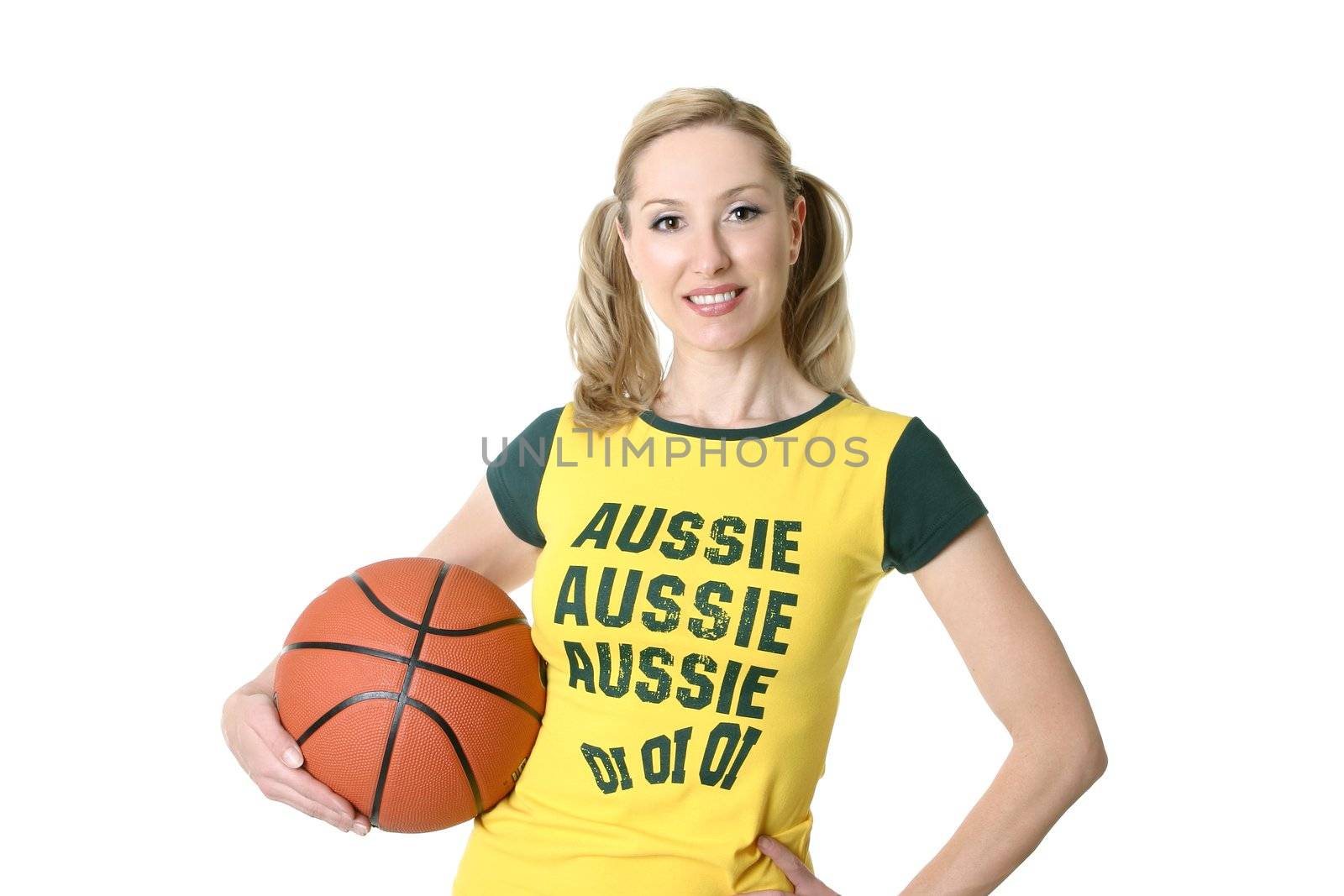 A fit female holding a basketball on a white background.