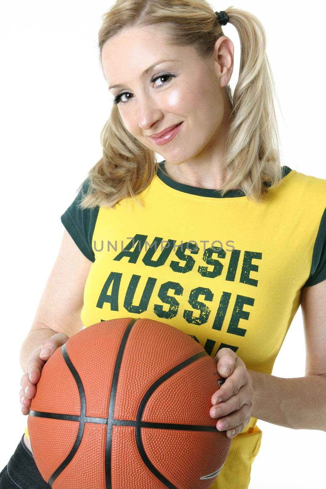 Smiling female holding a basketball.