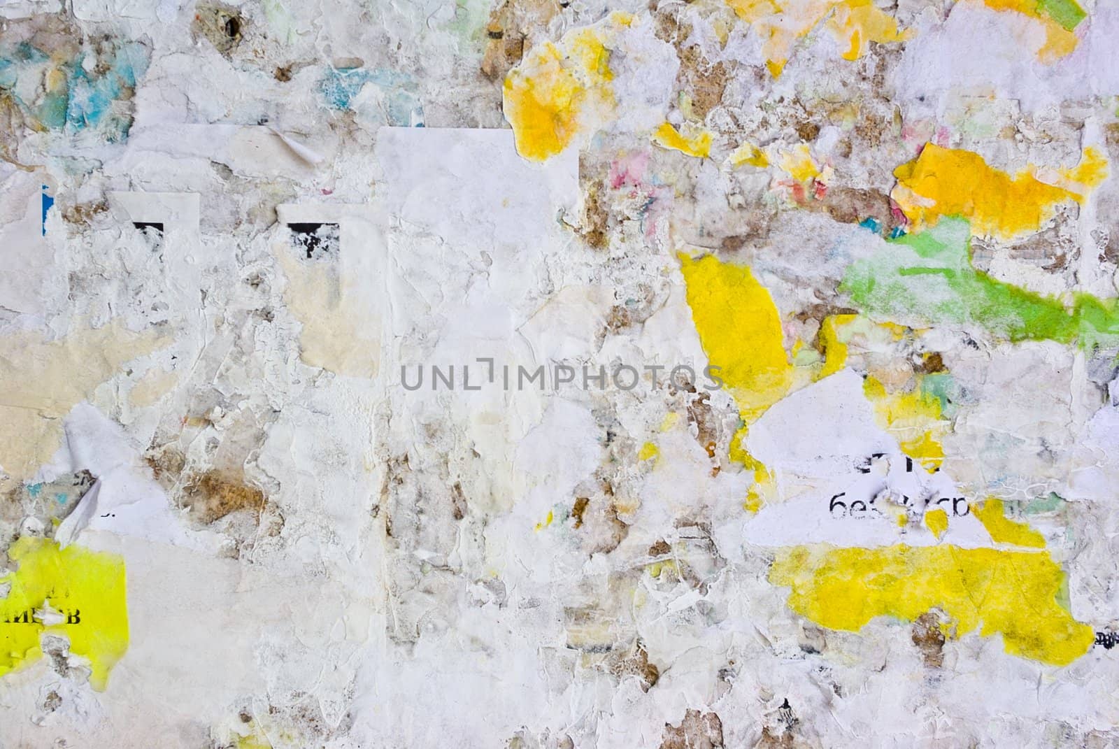 remains of posters and advertisements on old wall