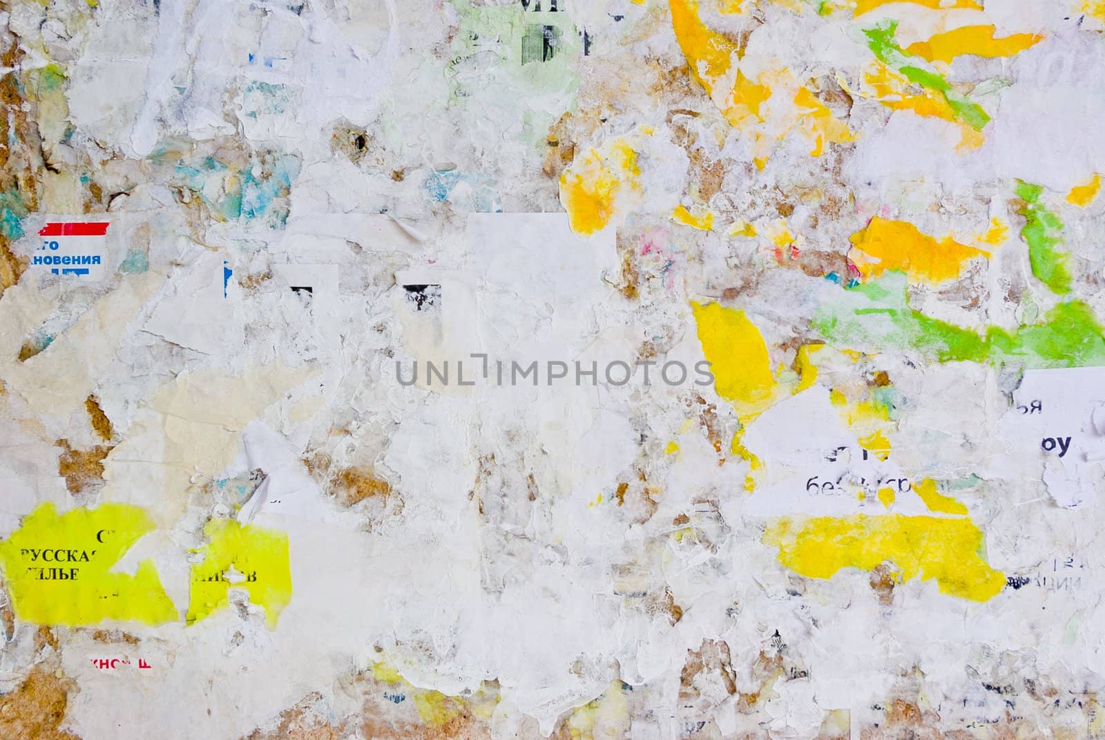remains of posters and advertisements on old wall