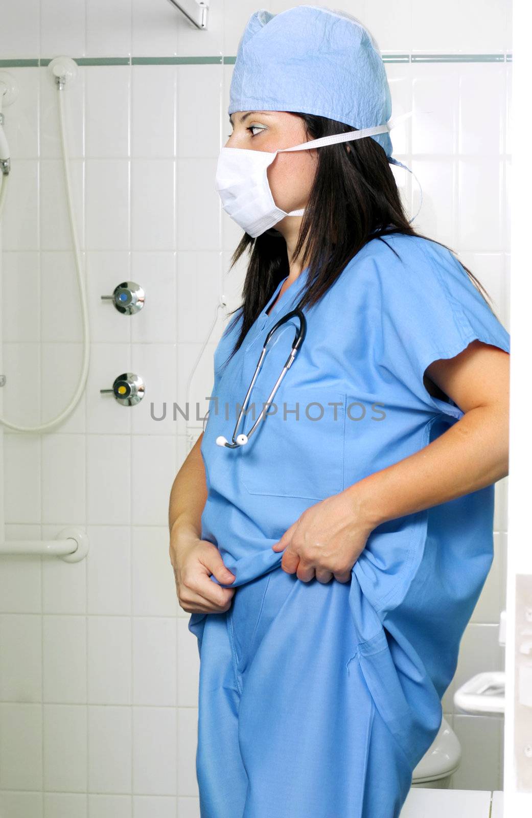 Surgeon putting on scrubs uniform
