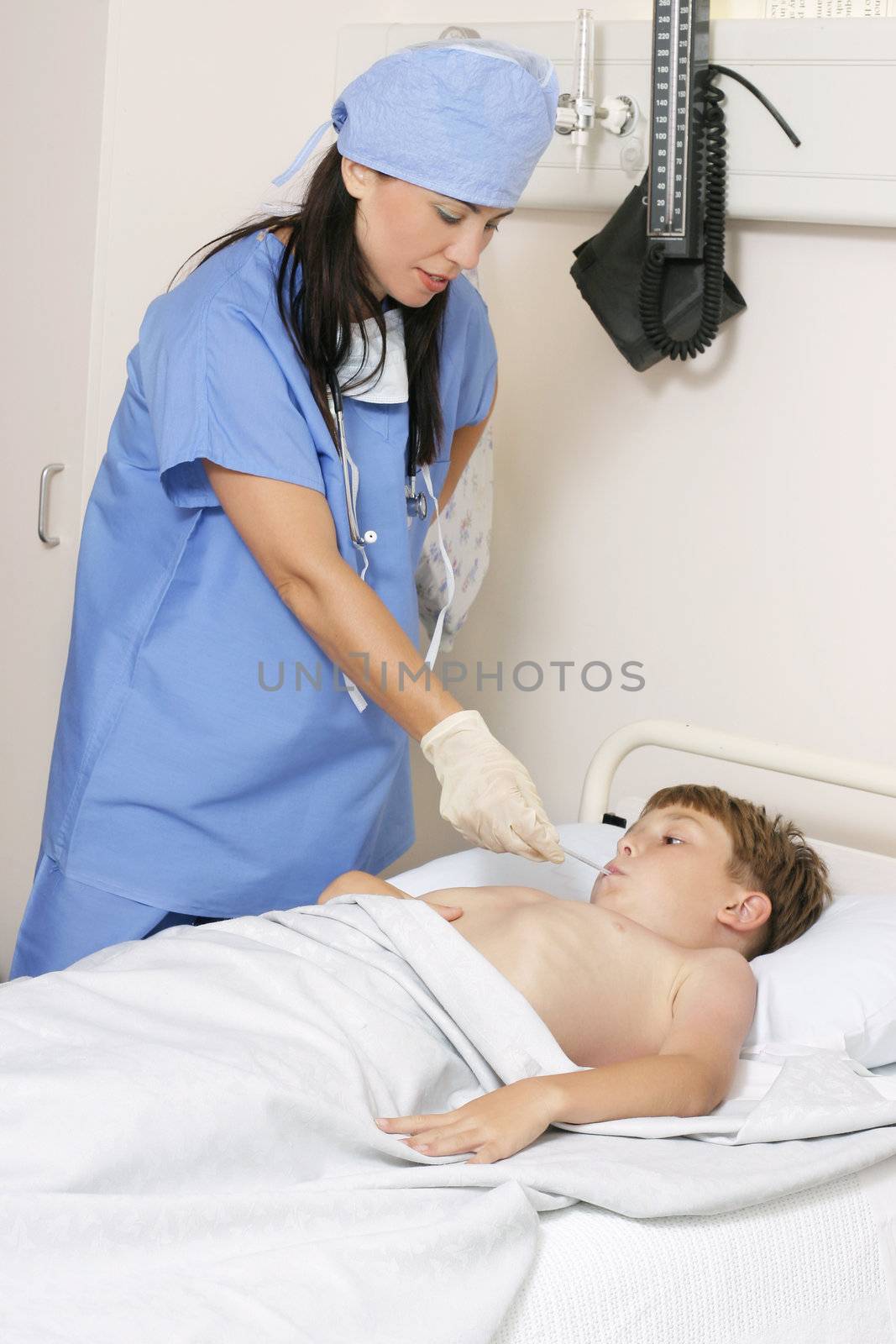 Nurse in scrubs takes a child's temperature

