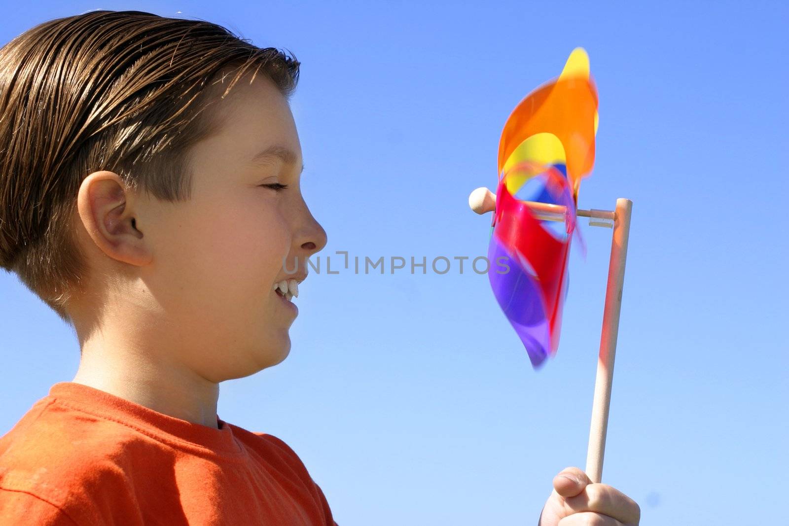 Childs amusement watching a spinning pinwheel toy closeup
