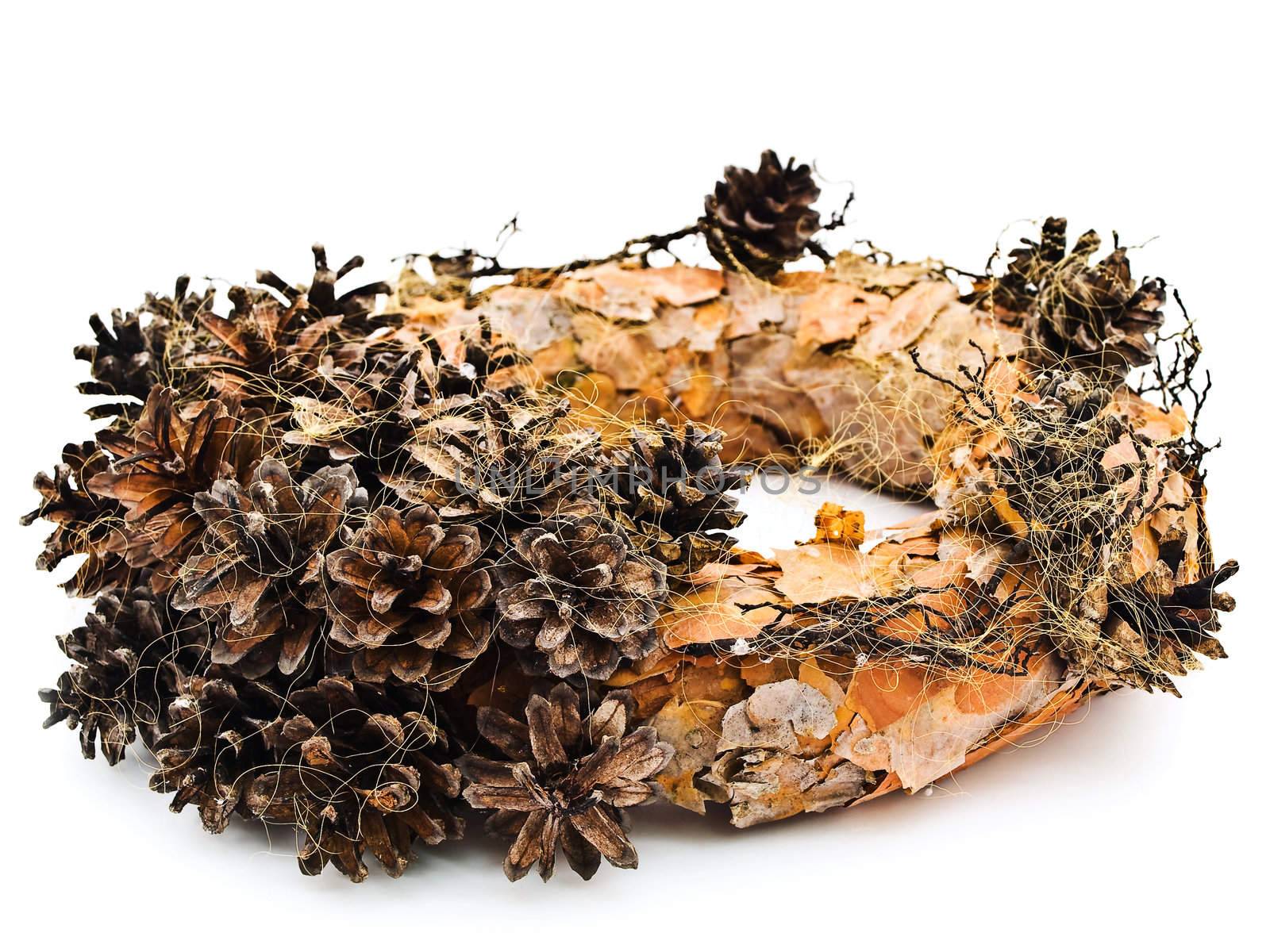 Handmade garland from pine tree rind and cones against the white background