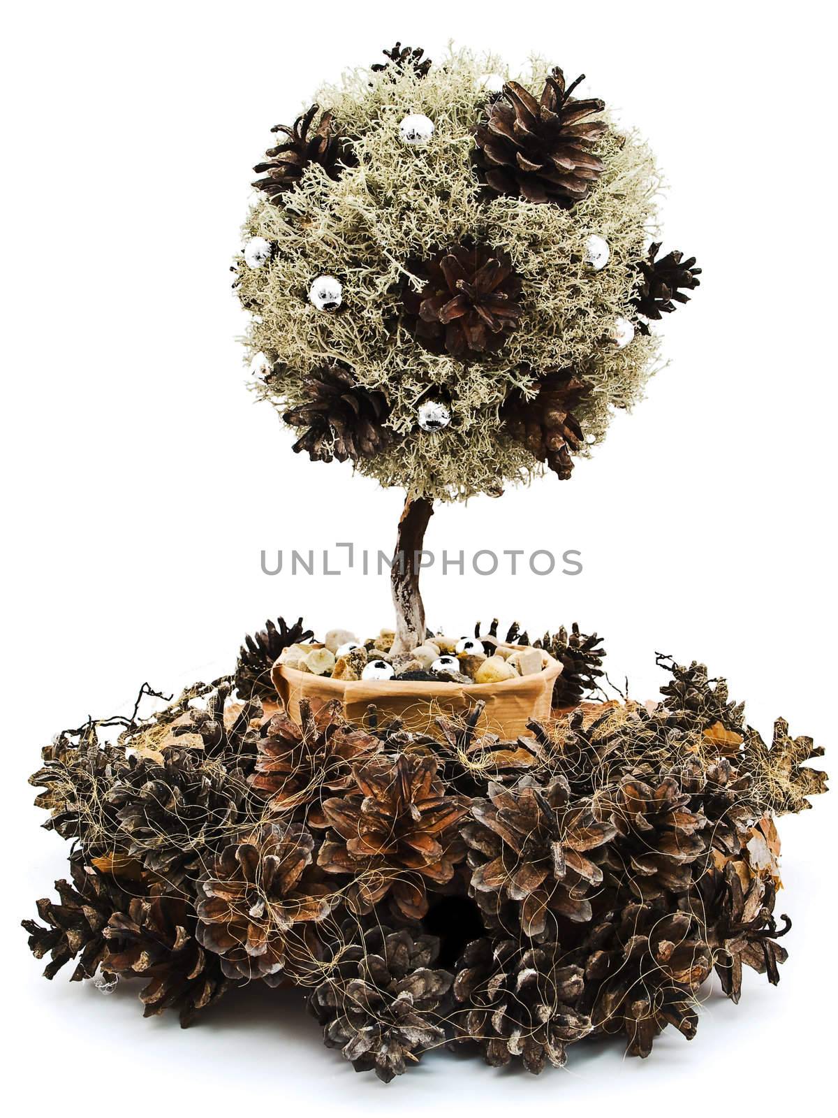 Handmade decorative tree into garland from pine tree rind and cones against the white background