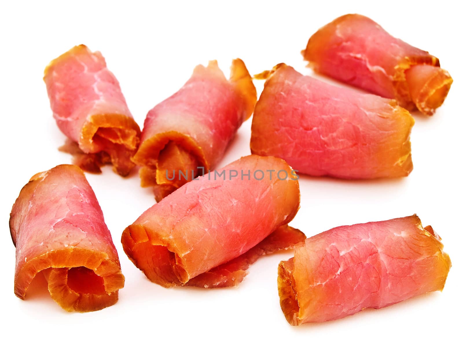 photo of the red tasty smoked rolled meat against the white background 