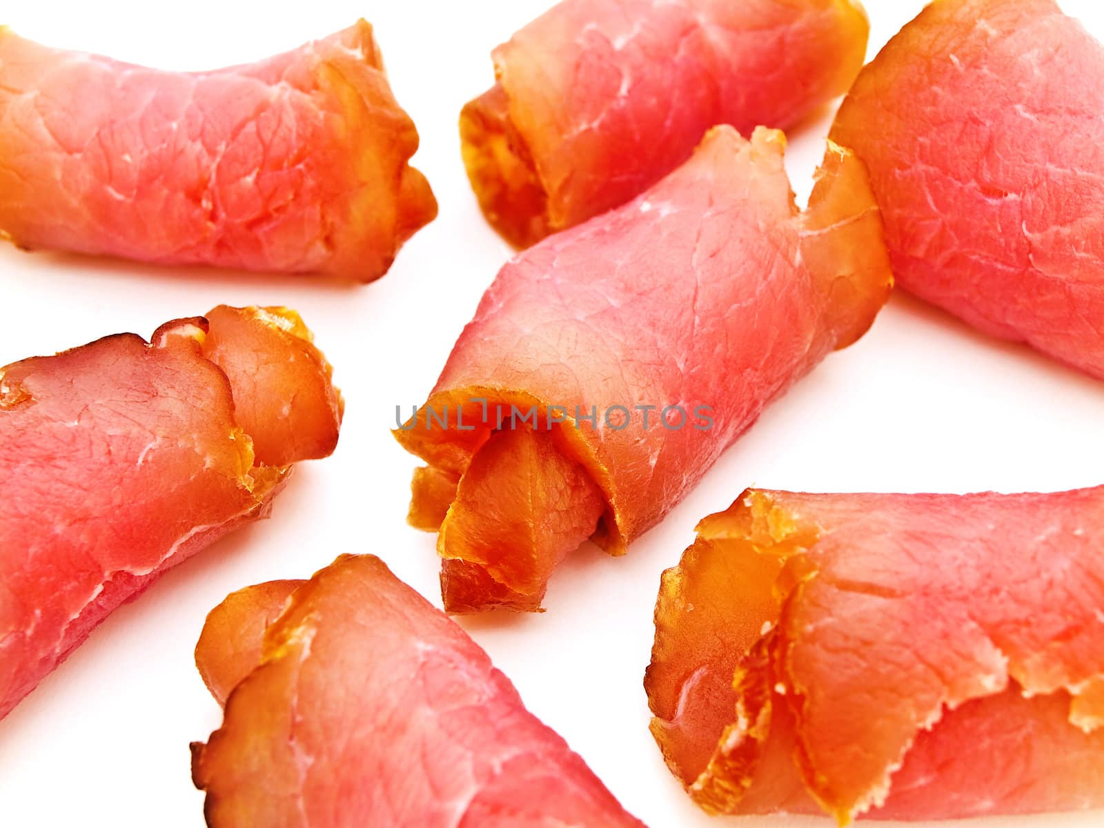 Close up photo of the red tasty smoked rolled meat against the white background 