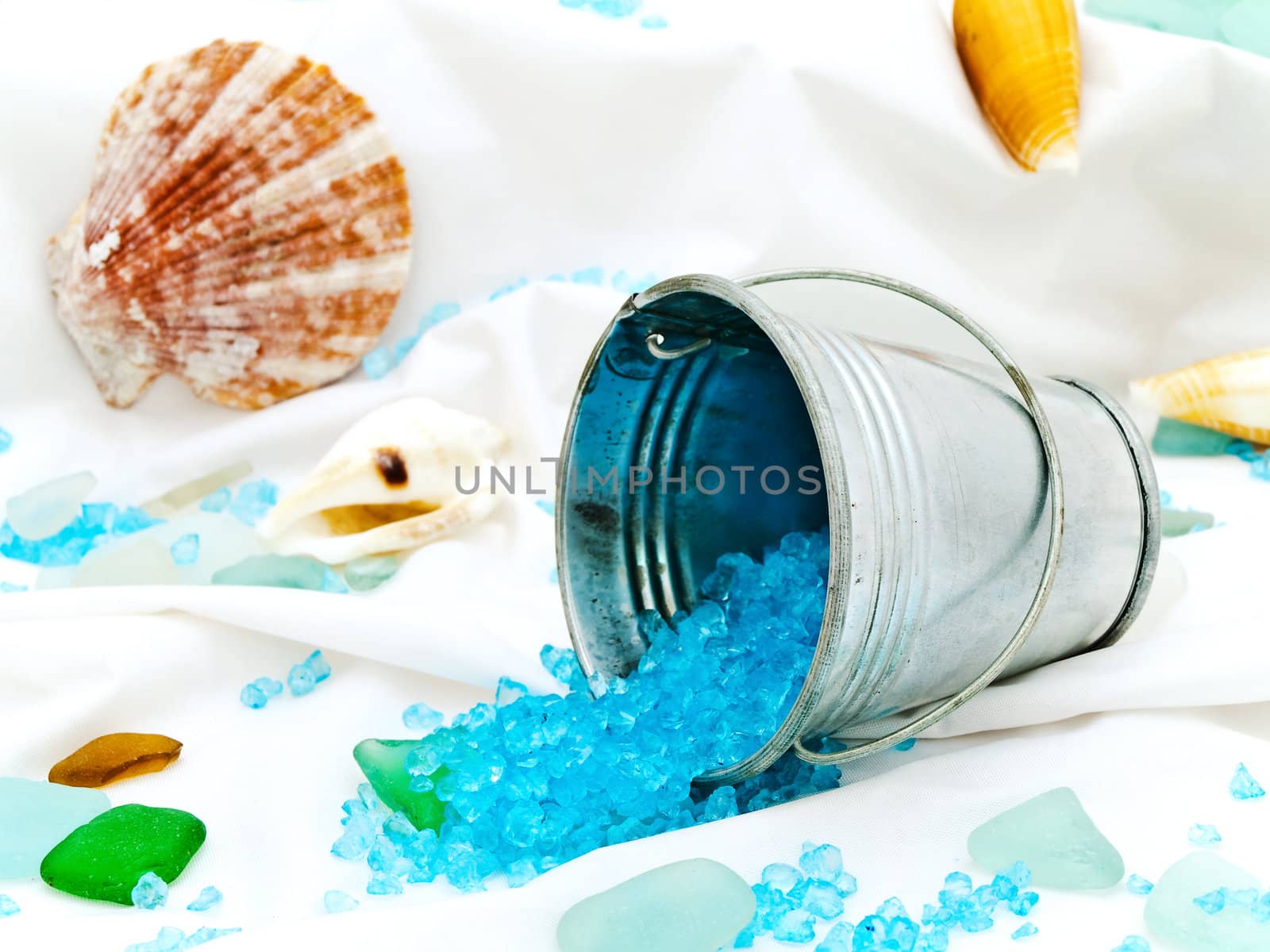 marine decor with sea shells, bucket and decorative stones at white