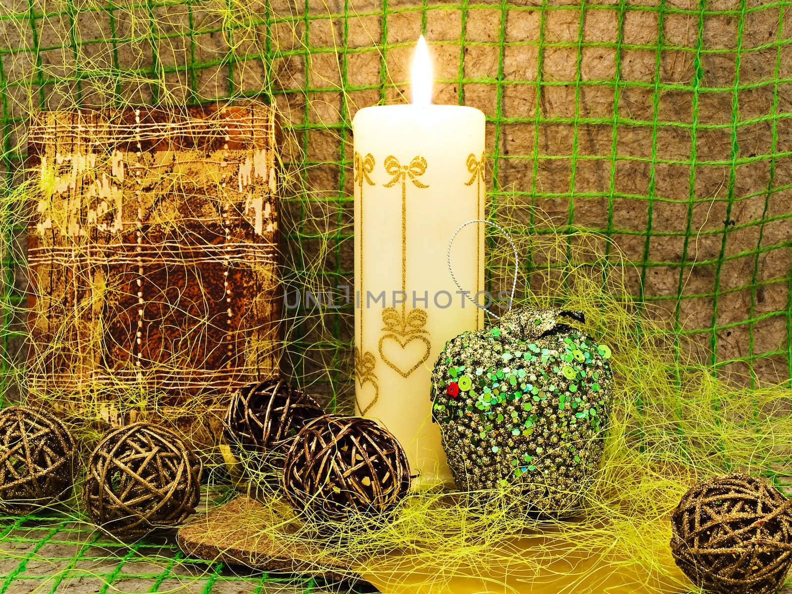 New Year composition with gift, candle and toys against abstract background 