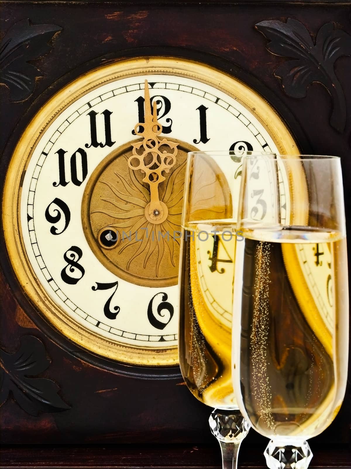Composition with old clock and two glasses of champagne  