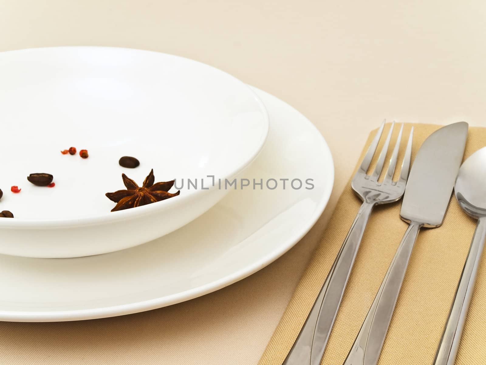 table serving with  anise stars, red pepper, coffee beans at beige tablecloth