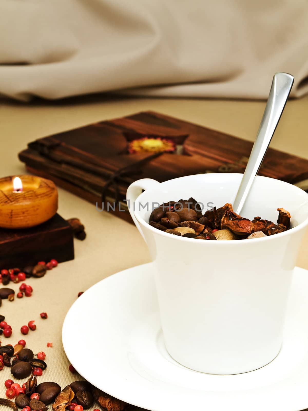 decorated table serving with candle, coffee beans near cup at beige 