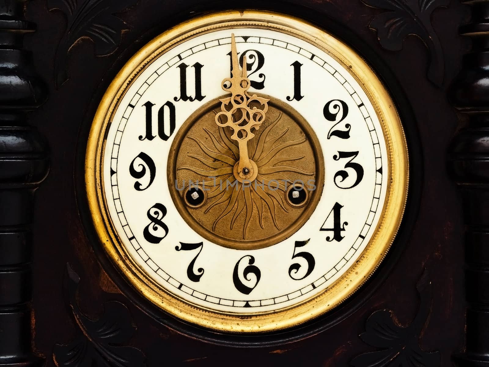 old wooden clock with  golden hands show twelve  