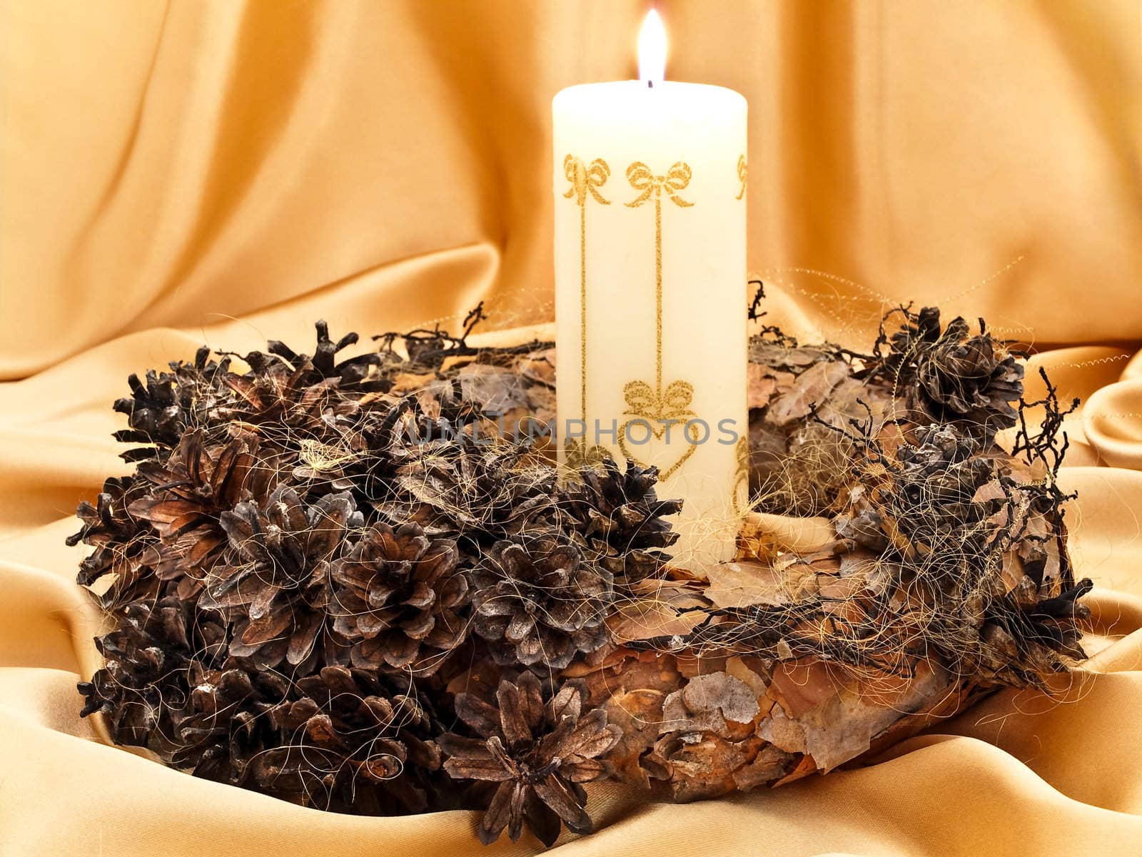 handmade garland with candle against golden background