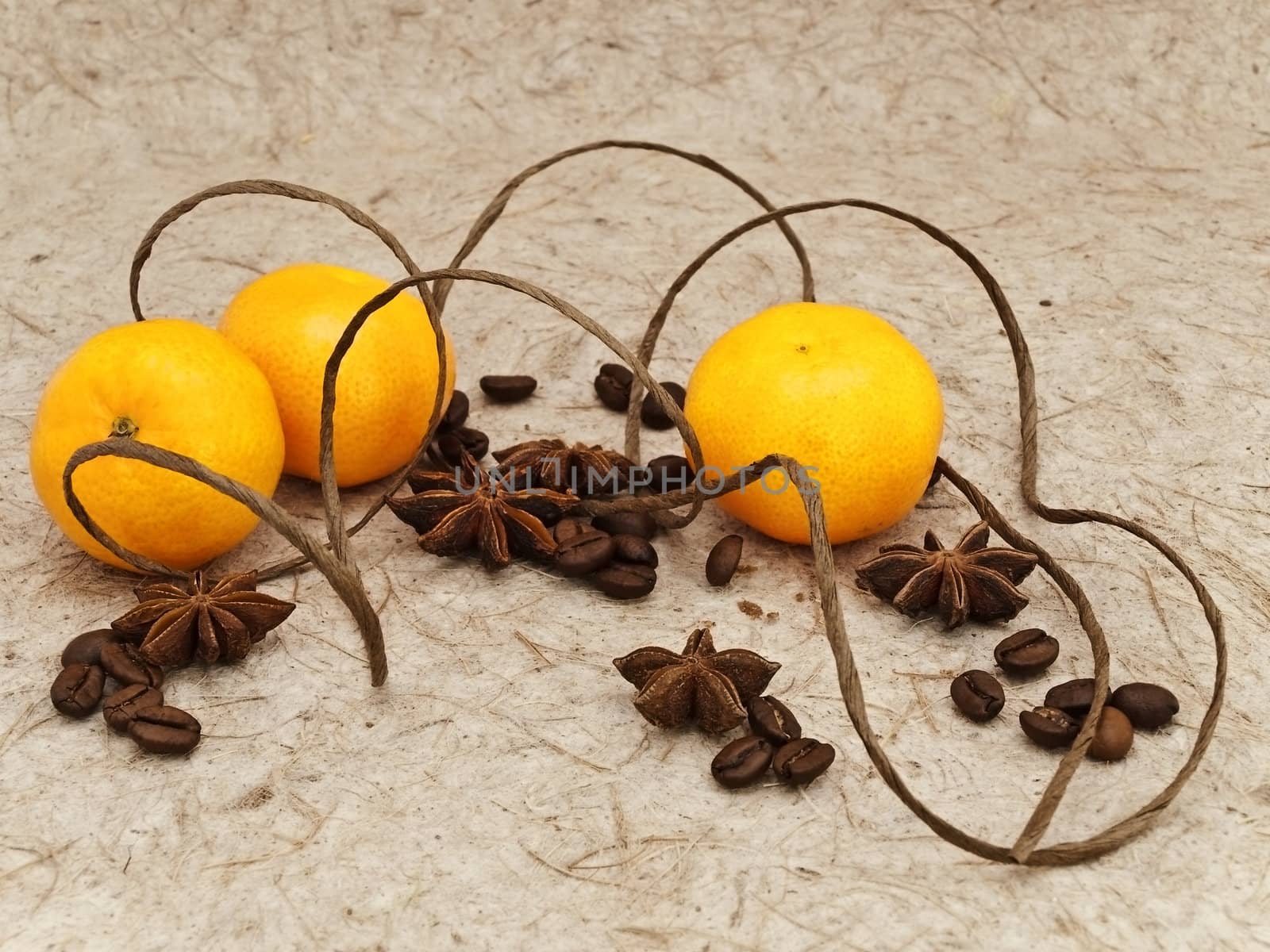 decoration with mandarins, anise stars and coffee beans against beige background