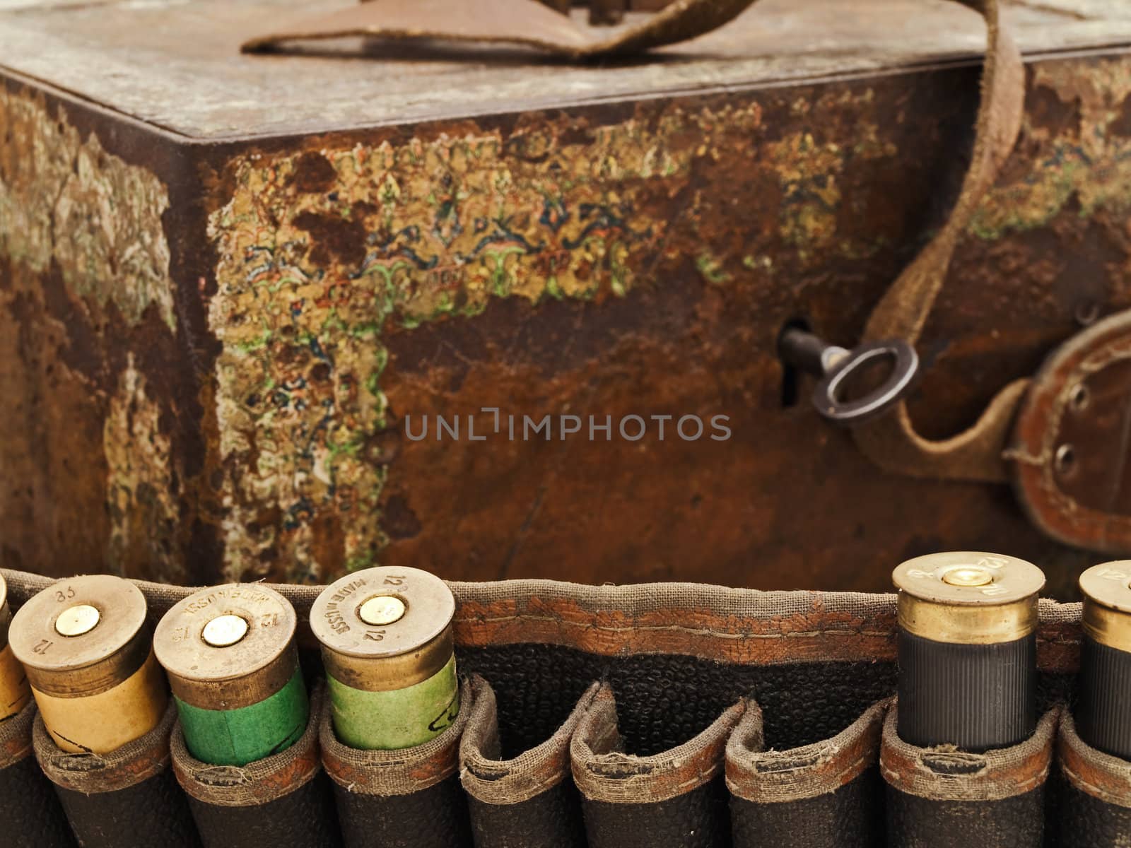Some old cartridge for hunting rifle against vintage rusty chest